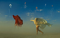 Burning man women playing with the wind on playa