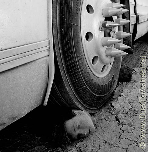 Burning Man 2009 Safety-Stop Desert Art Festival in Deep Desert Black Rock City Bus Wheel Head under the wheel