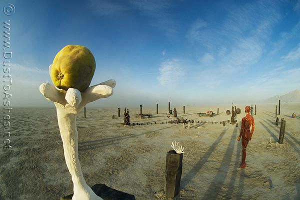 Evolution-Reaching-for-Balance-Detail-by-Daniel-James-Park-Sculpture-Art-Burning-Man-2009-Evolution-Desert-Nevada-Gerlach-DustToAshes-Ales hand holding the apple sculpture