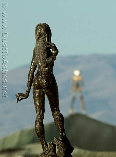 Detail bronze art installation looking at the Burning Man edifice