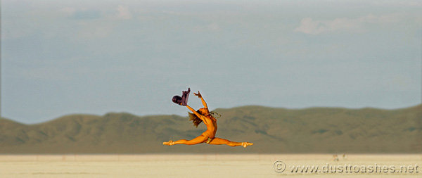 Burning Man dancing girl in the desert