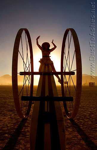 Burning Man girl on mobile teeter totter
