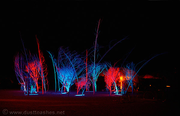 Colorful burning man theme camp at night