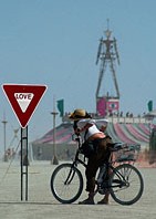 Woman looking at Love traffic sign in desert