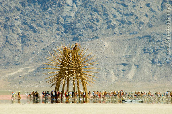 People gathering around starry bamboo art installation