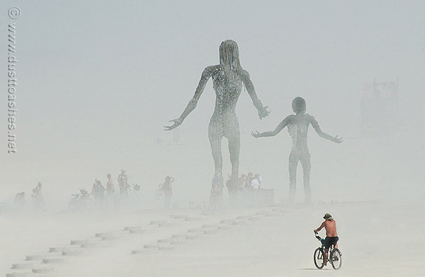 rising art statues in dust storm