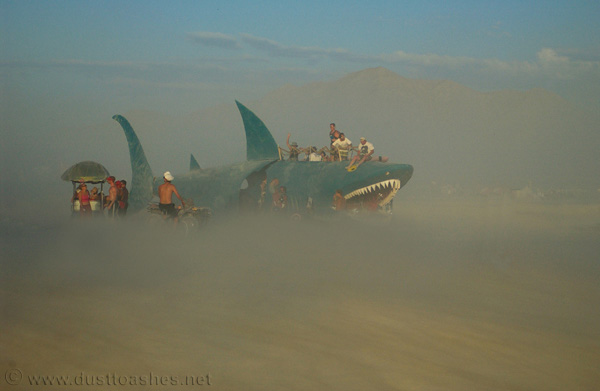 Desert fish art car cutting thru the dust storm