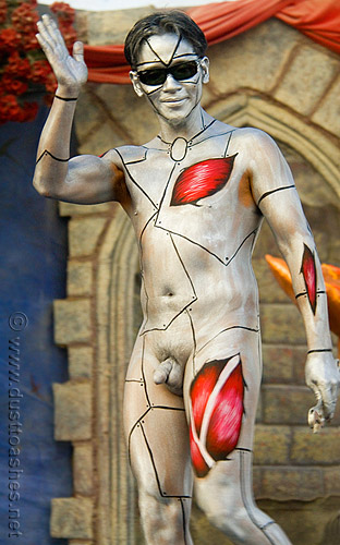 Silver body painte man with meat openings