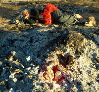 Girl sleeping next to hot glowing ashes after the night of Burn