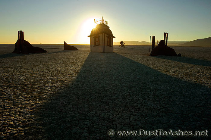 Sinking House in Desert House casting long shadow