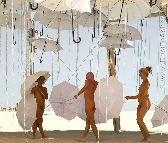People dancing with umbrellas in Wet Dream art installation
