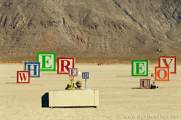 Perspective letter message cubes in desert